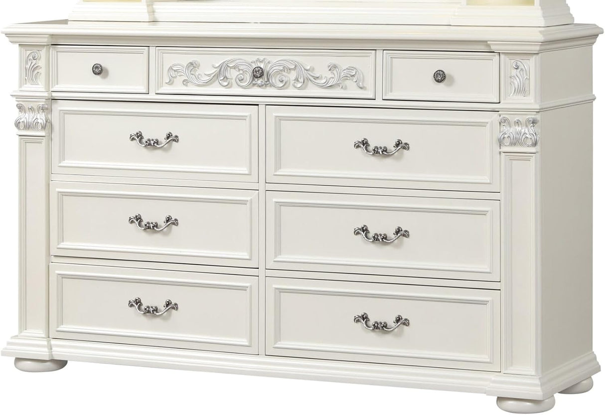 An ornate white wooden dresser with six drawers, decorative silver handles, and carved details on the front and sides, shown against a plain white background.
