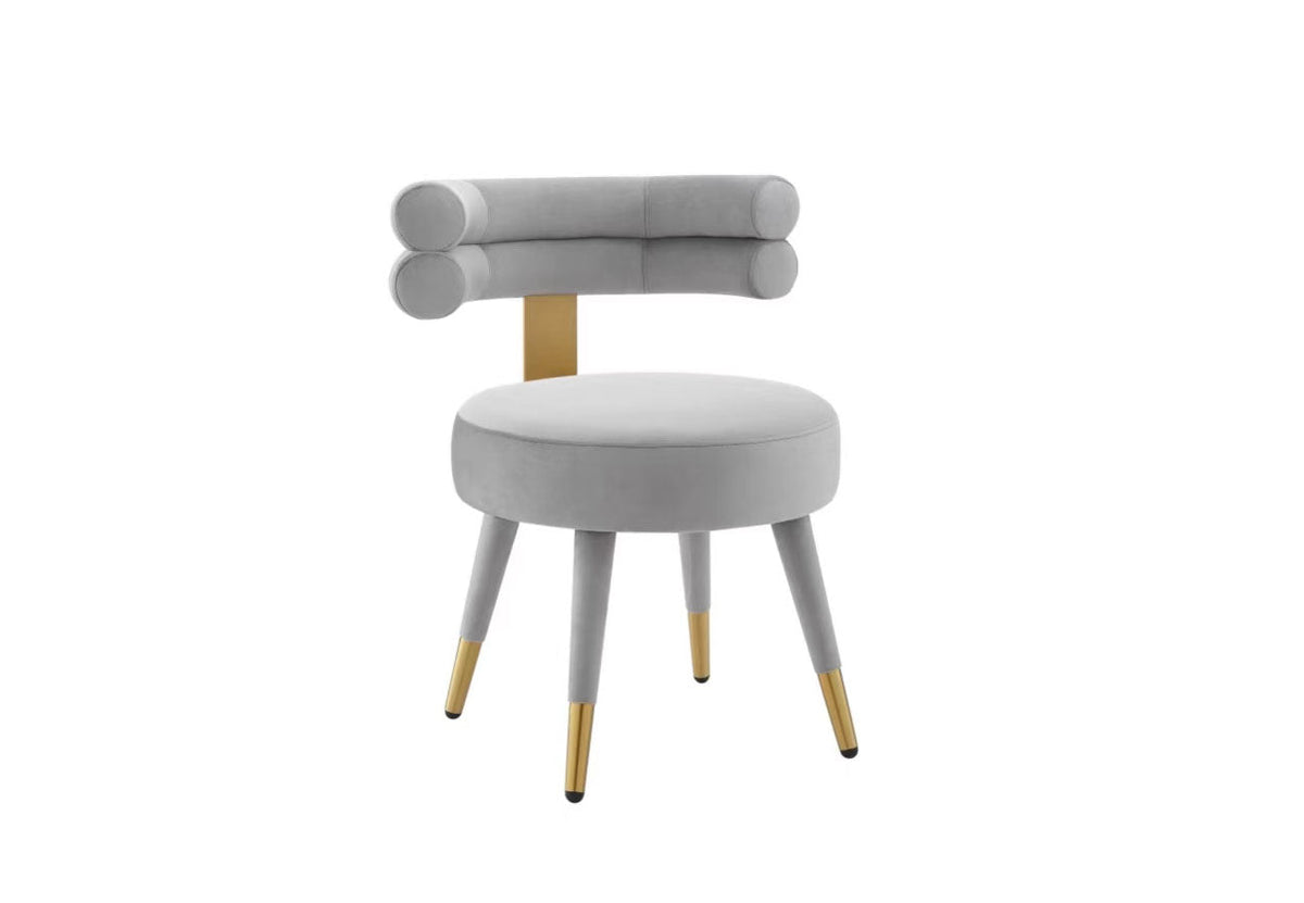 Close-up detail of the light blue performance velvet and cylindrical backrest geometry.