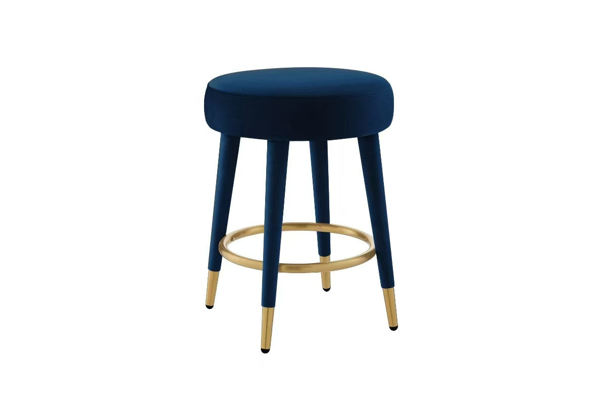 Detail shot of the circular gold footrest and tapered black stool legs.