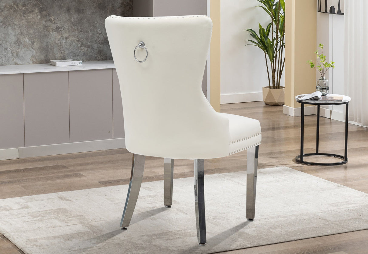 Front view of the cream velvet dining chair with gold tufted backrest and legs