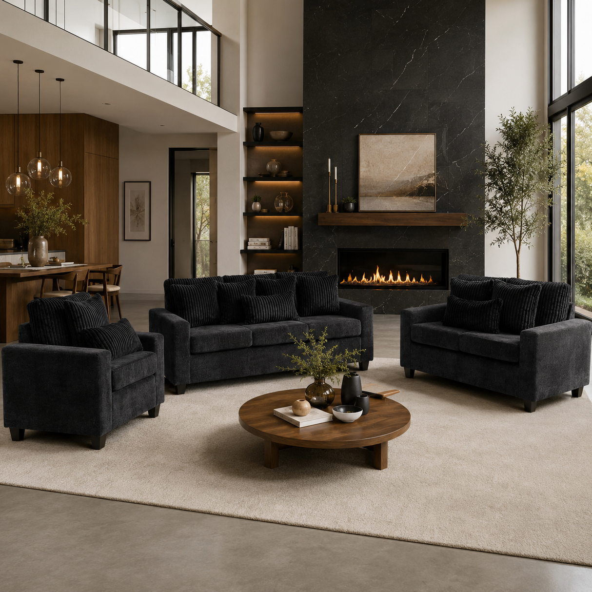 A modern living room featuring a dark charcoal gray three-piece sofa set (loveseat, armchair, and sofa) arranged around a round wooden coffee table on a large cream rug. The background showcases a contemporary black marble fireplace wall, built-in shelves, and a high-ceilinged loft-style interior.