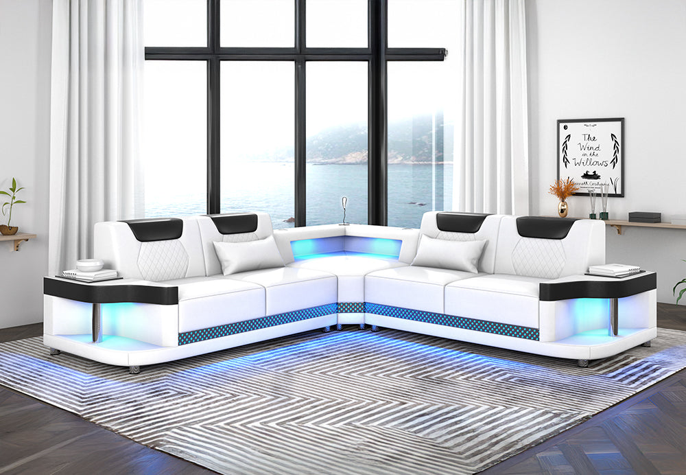 Contemporary white and black faux leather L-shaped sectional sofa with integrated LED lighting along the base.