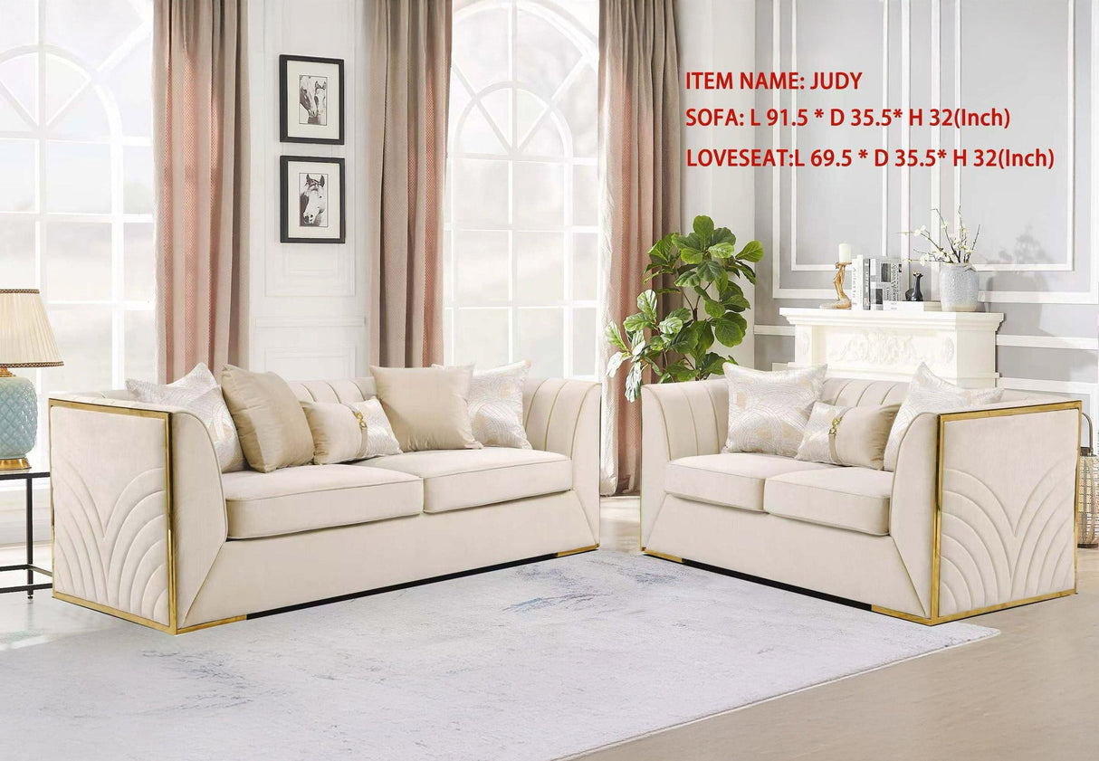 Modern living room arrangement featuring the Judy sofa and loveseat set with metallic gold trim.