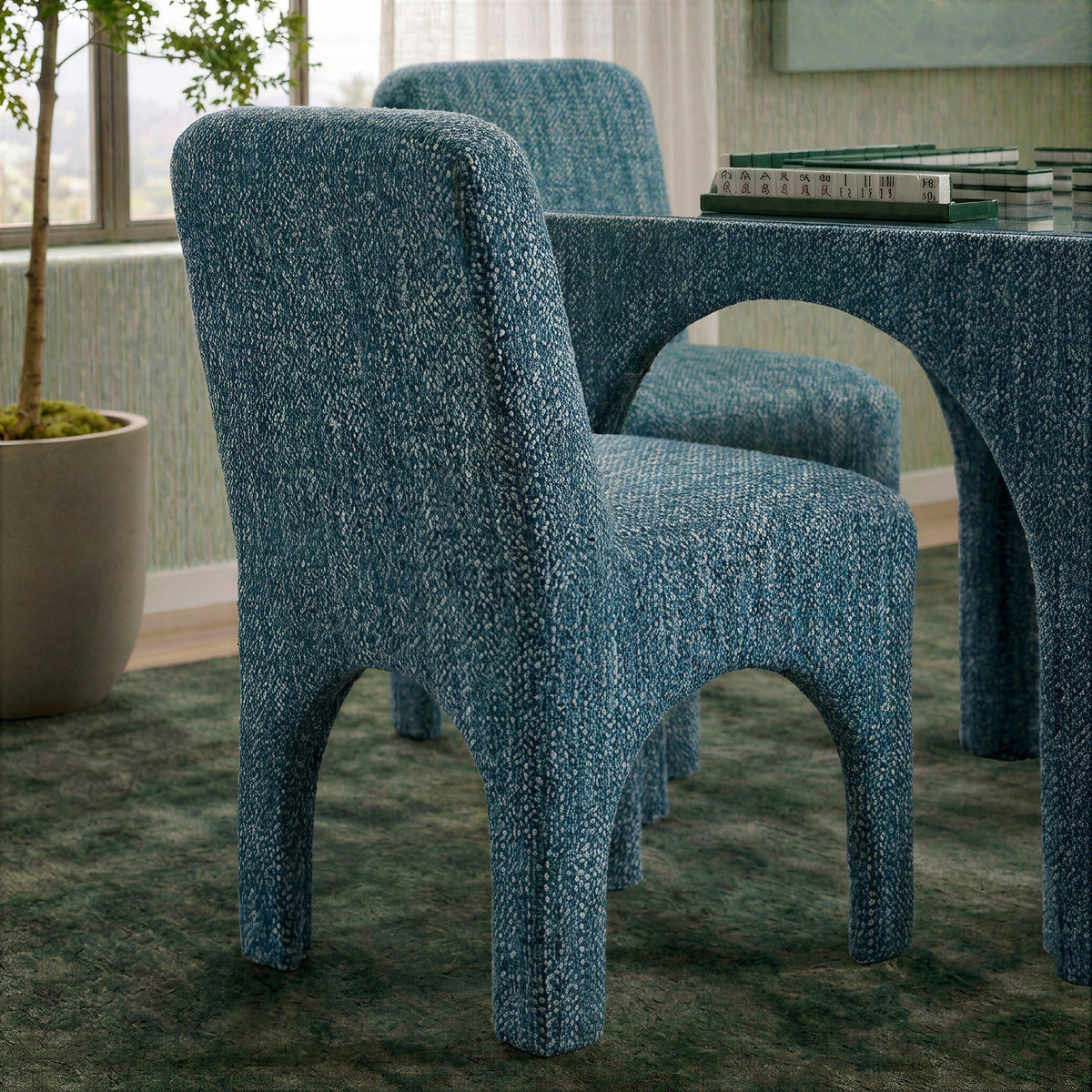 Cream Tomlin Performance Chenille Dining Chairs surrounding a natural stone dining table