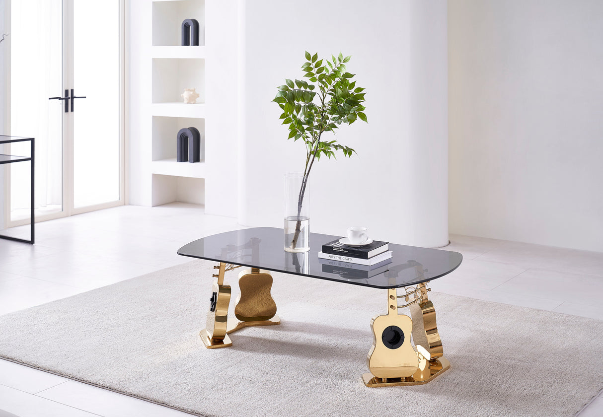 Majestic Coffee Table featuring a golden metal frame shaped like guitar silhouettes with a sleek black glass tabletop.