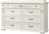 An ornate white wooden dresser with six drawers, decorative silver handles, and carved details on the front and sides, shown against a plain white background.
