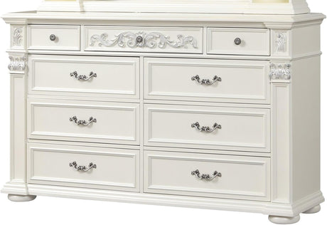 An ornate white wooden dresser with six drawers, decorative silver handles, and carved details on the front and sides, shown against a plain white background.