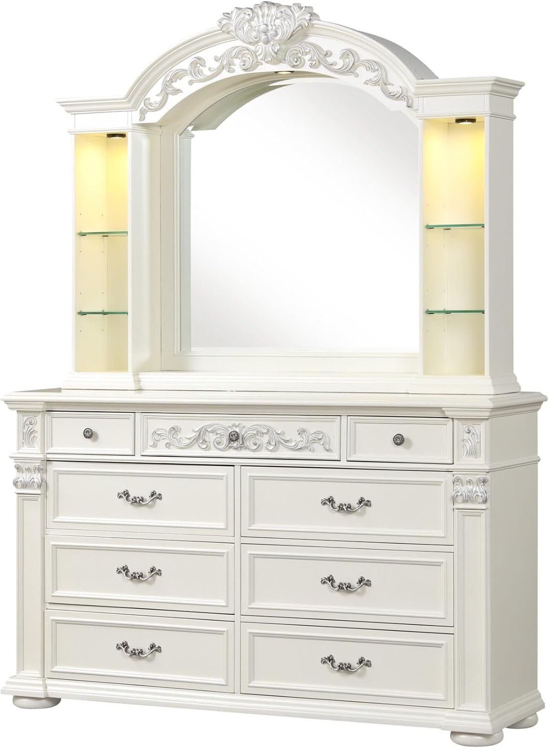 An ornate white wooden dresser with a matching arched mirror, featuring decorative carvings, six drawers, and illuminated side shelves.