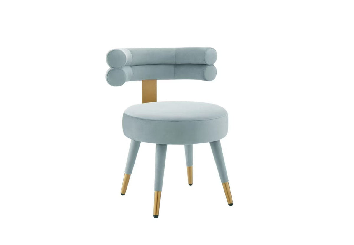 Side profile of the Velora velvet chair showing the round upholstered seat and tapered legs.