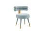 Side profile of the Velora velvet chair showing the round upholstered seat and tapered legs.