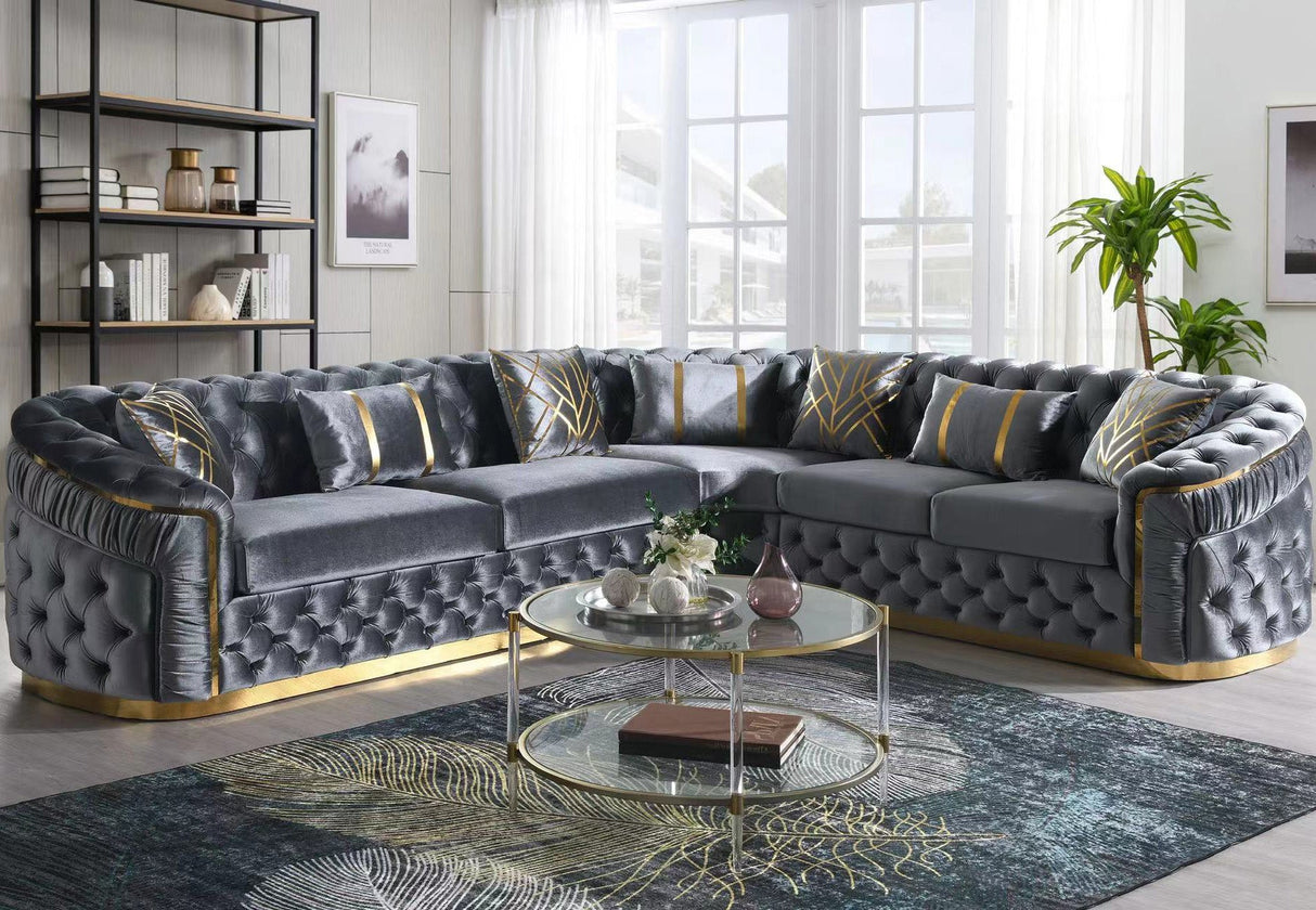 Gray velvet l-shaped sectional sofa with deep button tufting and gold metal legs