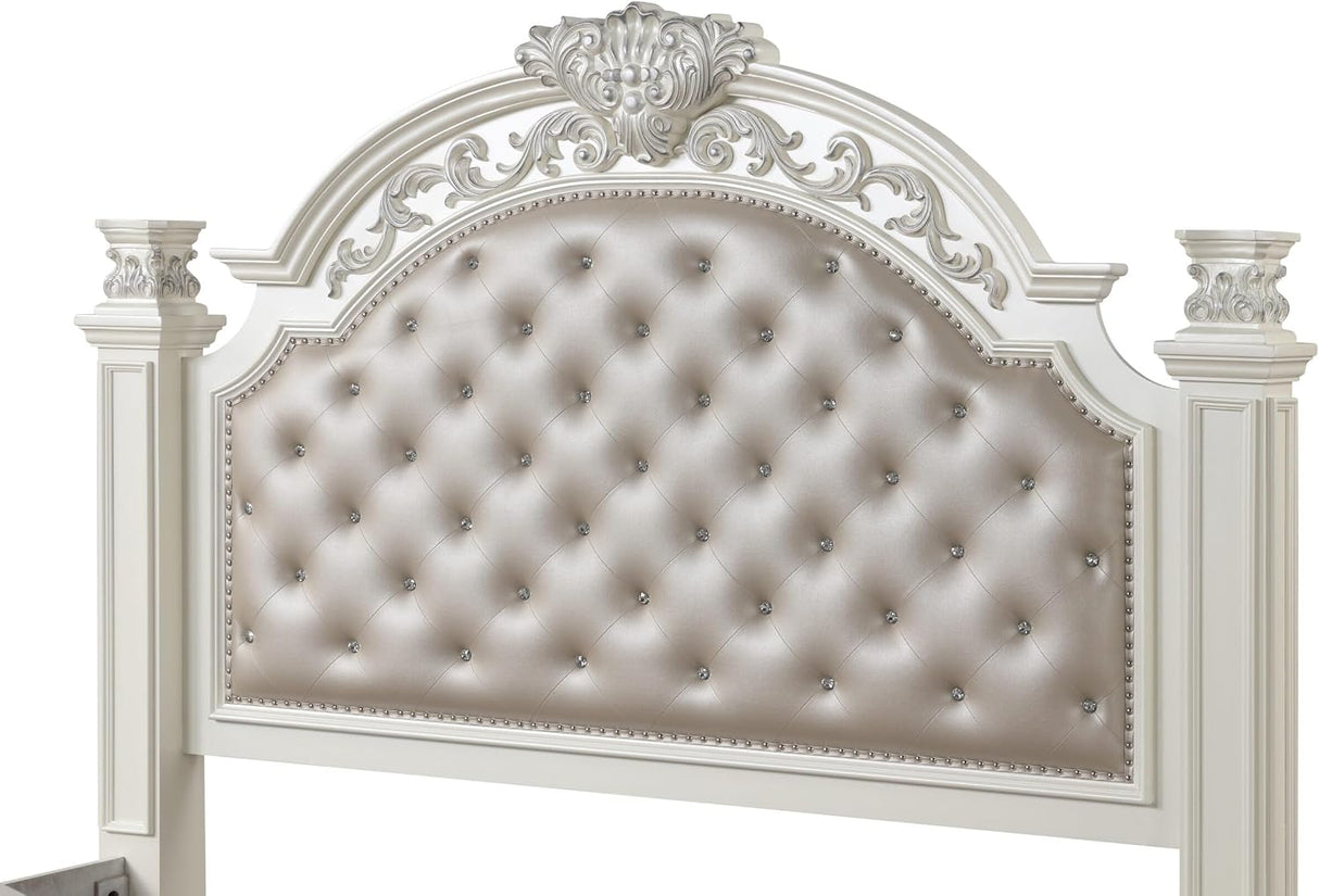 An ornate white upholstered headboard with a tufted center panel, decorative carved top, and matching side posts on a plain white background.