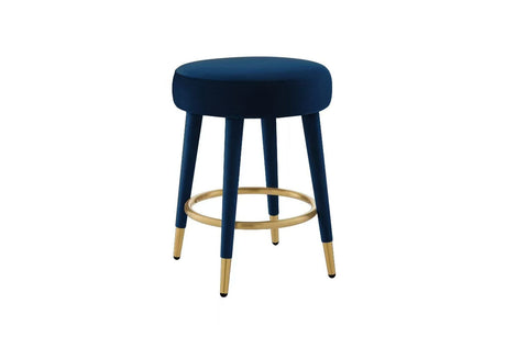 Detail shot of the circular gold footrest and tapered black stool legs.