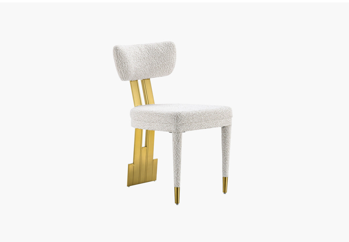 Amari Dining Chair featuring white textured upholstery and gold-finished rear leg accents.