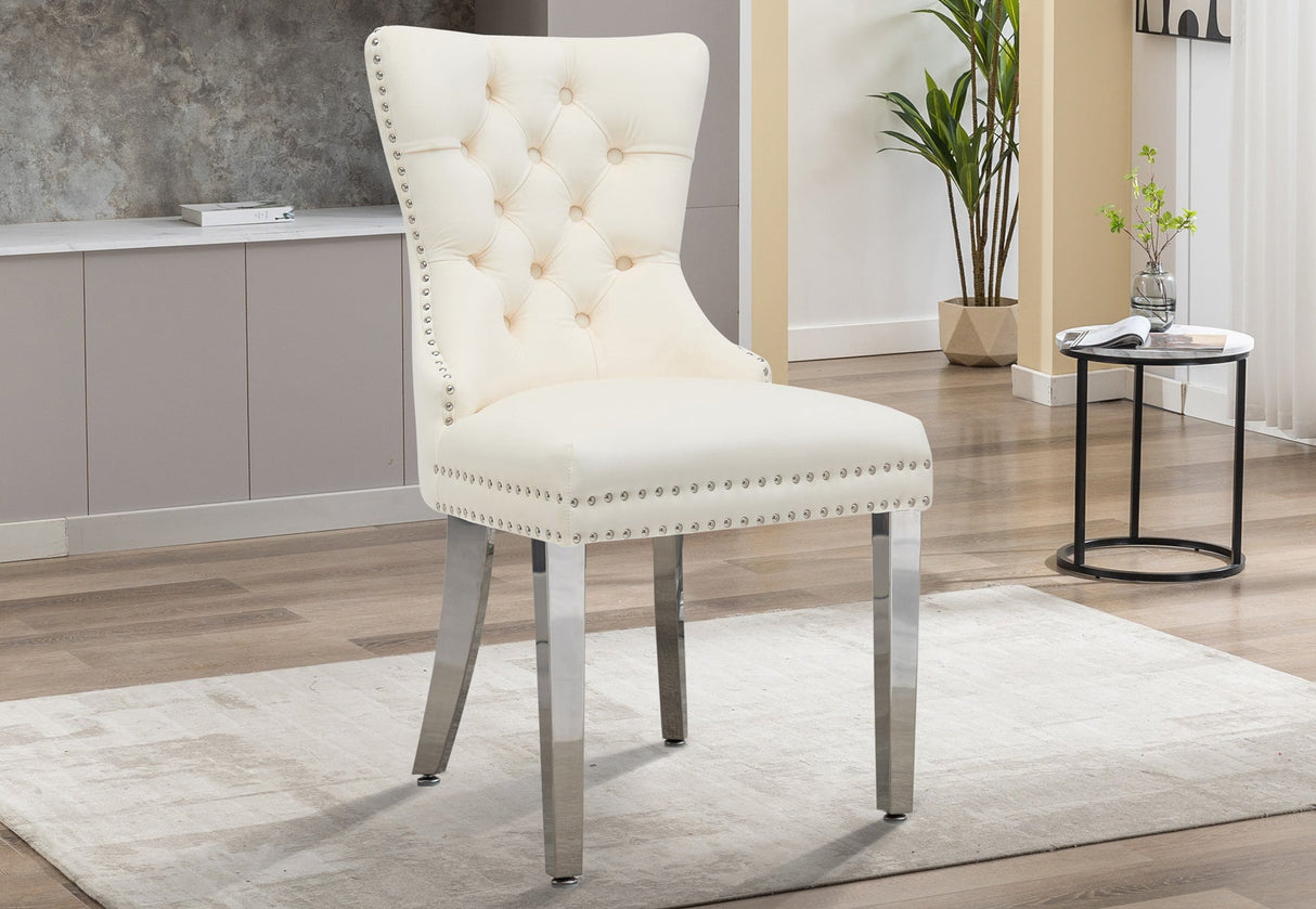 Angled side profile of the tufted dining chair showing gold nailhead trim