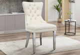 Angled side profile of the tufted dining chair showing gold nailhead trim