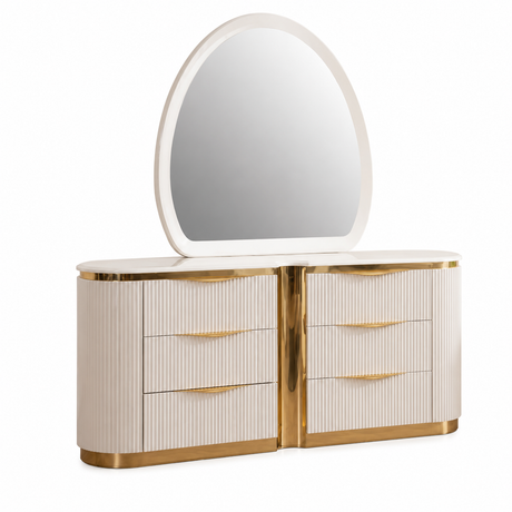 A modern vanity table with an attached oval mirror, featuring a cream-colored ribbed finish and polished gold metal trim and drawer pulls, set against a plain white background.
