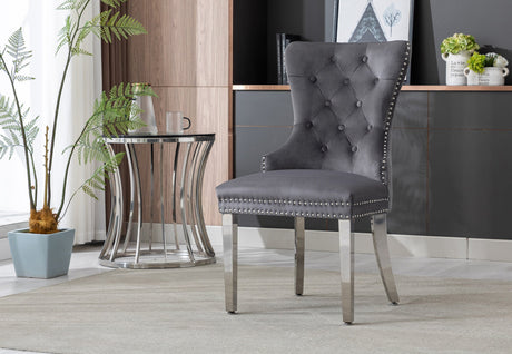 Two cream velvet dining chairs arranged in a contemporary dining room setting