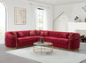 Modern living room setting featuring a gray velvet tufted corner sectional