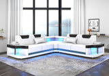 Contemporary white and black faux leather L-shaped sectional sofa with integrated LED lighting along the base.