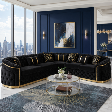 A luxury curved black velvet sectional sofa with gold piping and tufted detailing, set in a modern living room with a blue accent wall, city skyline window view, and a glass coffee table.