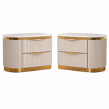 A pair of modern nightstands with cream ribbed fronts, white marble tops, and gold metal trim and drawer pulls, shown on a plain white background.