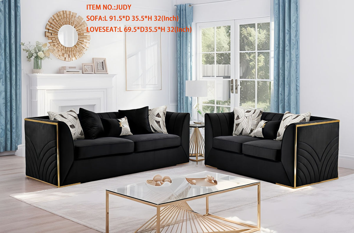 Judy grey velvet sofa and loveseat set with vertical channel tufting and gold base accents.