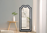 The Nini LED wall mirror mounted in a contemporary bedroom setting for functional grooming and decor.