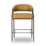 Set of tan Tatum counter stools lined along a natural stone kitchen island