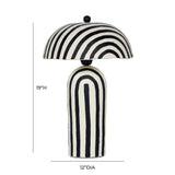 Maiori striped table lamp illuminated on contemporary wooden bedside nightstand