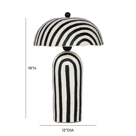 Maiori striped table lamp illuminated on contemporary wooden bedside nightstand