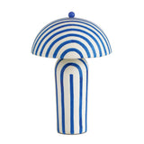 Maiori striped luminaire styled next to books and ceramic vase
