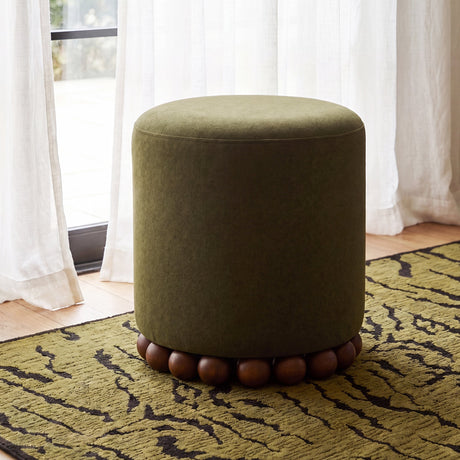 Studio product photograph of Dex round cushioned footstool