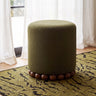 Studio product photograph of Dex round cushioned footstool