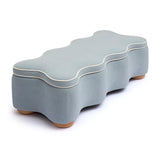 Angled perspective of blue Thalia scalloped velvet storage bench