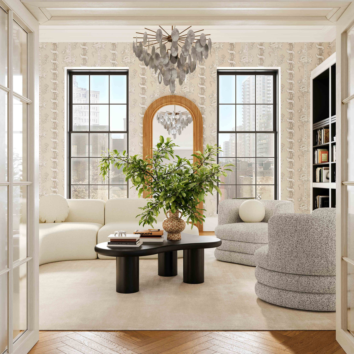 Grey boucle swivel accent chair paired with a black organic modern coffee table in a luxury living room.