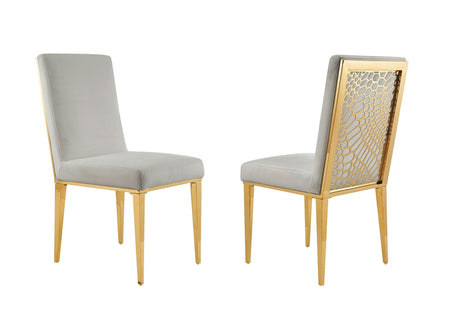Side profile of two Shelly velvet chairs showing the tapered gold legs.
