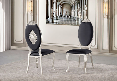 Front view of the Yara black velvet dining chair featuring an oval backrest and polished silver metal frame.