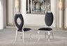 Front view of the Yara black velvet dining chair featuring an oval backrest and polished silver metal frame.