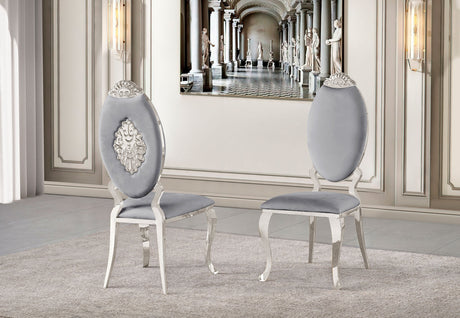 Side profile of the black velvet dining chair highlighting the curved silver-finished legs and ergonomic back.