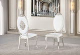 Close-up detail of the black velvet upholstery and polished silver metal trim on the oval backrest.