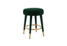 Close-up of the plush black velvet upholstered seat on a modern stool.