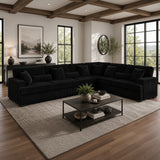 Modern living room with a black sectional sofa, coffee table, and decorative elements.