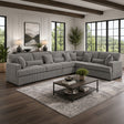 Gray sectional sofa in a living room with large windows and decor.
