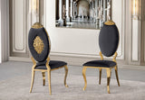 Front view of the Yara black velvet dining chair featuring an ornate gold oval backrest and gold legs.