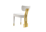Front view of Amari armless dining chair showing tapered legs with gold-capped tips.