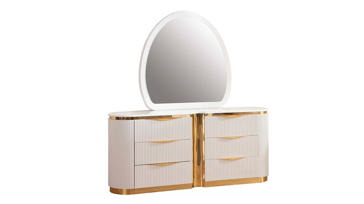 Close-up of white high-gloss dresser with integrated gold metal drawer pulls.
