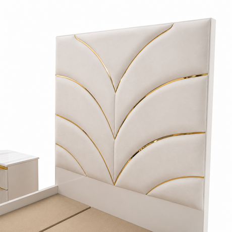 An off-white upholstered headboard with a geometric leaf-like pattern accented by shiny gold metallic trim, shown against a white background.