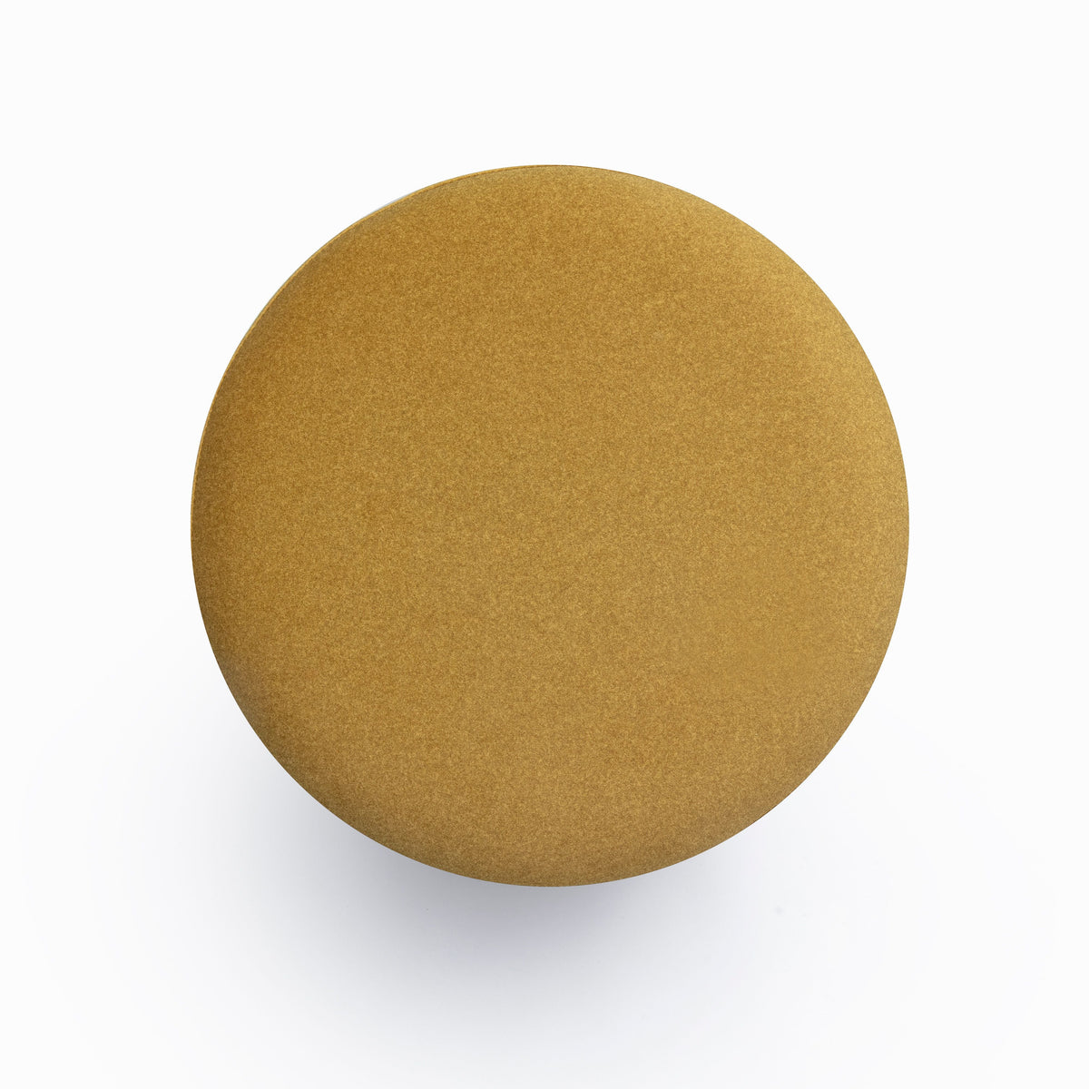Dex round upholstered ottoman three-quarter studio view
