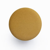 Dex round upholstered ottoman three-quarter studio view